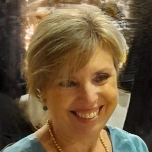 Manuela smiling in green dress