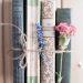 four assorted-title books tied up with a cord and flowers